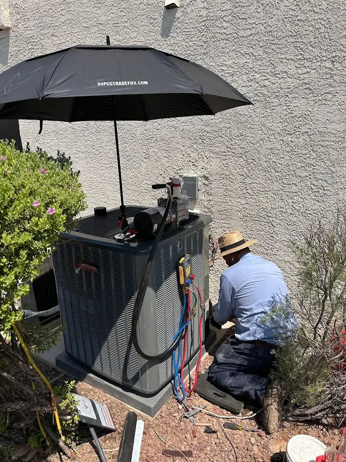 HVAC technician performing outdoor AC maintenance in Moultrie